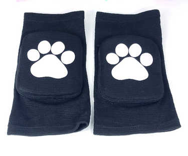 Black padded knee pads with white paw print design pair front view on white background.