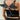 Black faux leather angel wing body harness with silver O-rings worn on model back view.