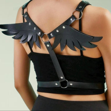Black faux leather angel wing body harness with silver O-rings worn on model back view.