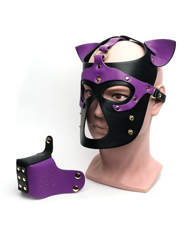 Purple and black leather bondage puppy hood mask with ears and removable muzzle on mannequin head.