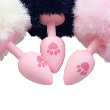 Pink silicone anal plug with fluffy bunny tail close-up detail view.