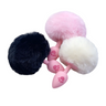 Pink silicone anal plug set with black white and pink fluffy bunny tail on white background.