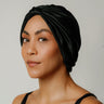 Black organic silk hair bonnet worn on model front view.