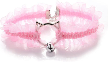 Pink choker necklace with silver ring and bell close-up. 