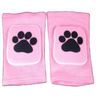 Pink padded knee pads with white paw print design pair front view on black background