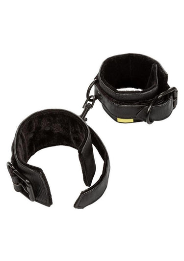 Close-up of black plush padded wrist cuff showing soft interior lining and buckle closure.