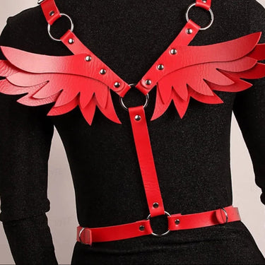 Red faux leather angel wing body harness with silver O-rings and stud accents worn on model.