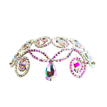 Close-up of rhinestone headpiece showing pink crystal centerpiece and iridescent stone detailing.